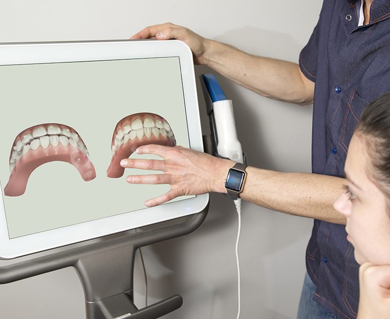 Dentist and patient looking at smile images on chairside computer