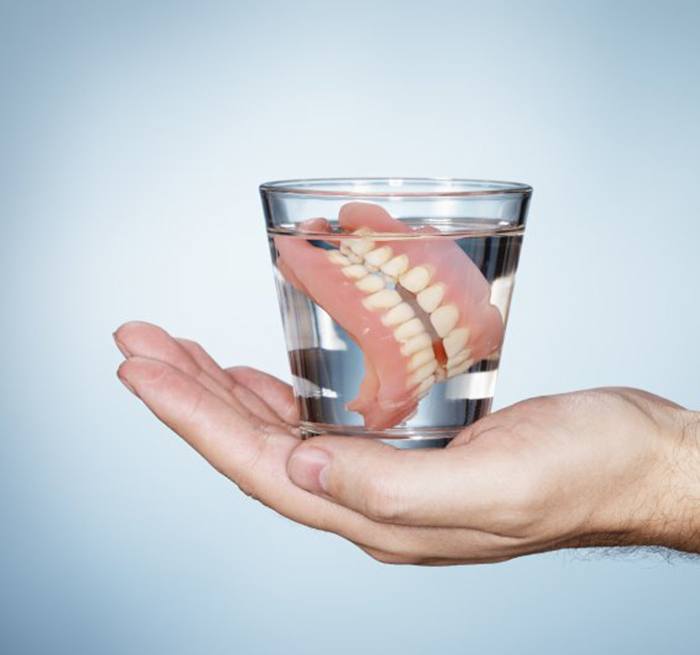 Dentures in Grand Prairie in glass of water