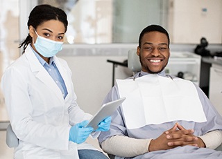 Dentist and patient smiling at appointment