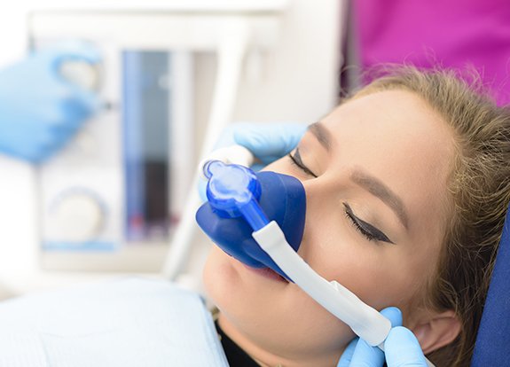 Patient with nitrous oxide sedation dentistry mask in place