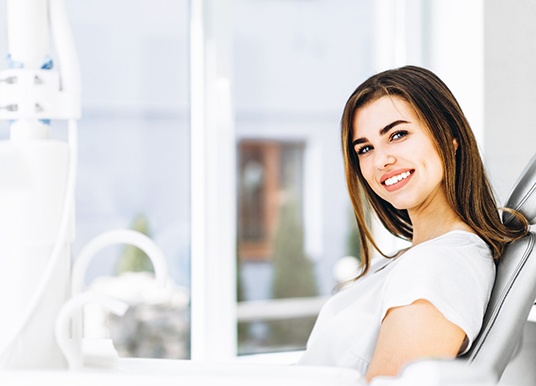 Female patient with dental implants in Grand Prairie, TX smiling