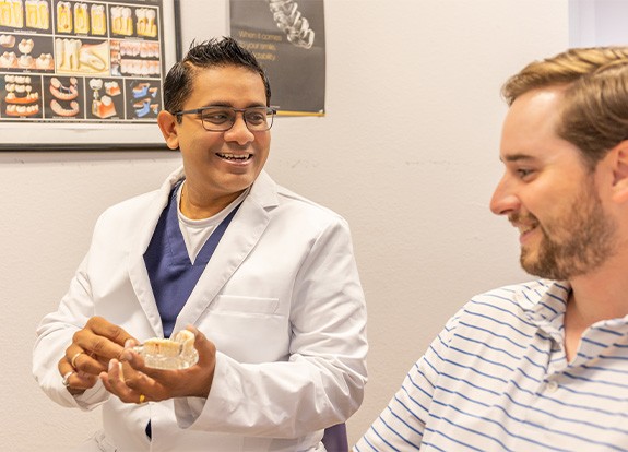 Doctor Desai talking to dental patient