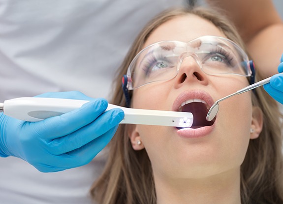 Dentist capturing intraoral images of patient's smile