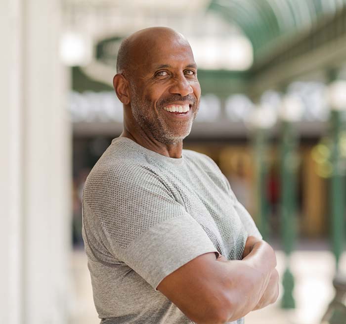 Confident man with all-on-4 in Grand Prairie smiling outside 