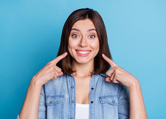 Dentist applying ultraviolet light to patient’s dental bonding