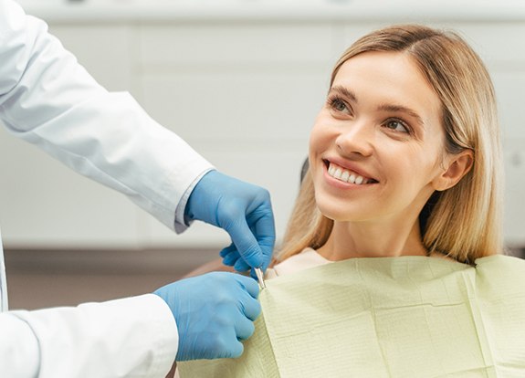 Closeup of woman’s teeth reflected in dental mirror