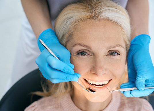 Woman smiling during a dental checkup and cleaning appointment