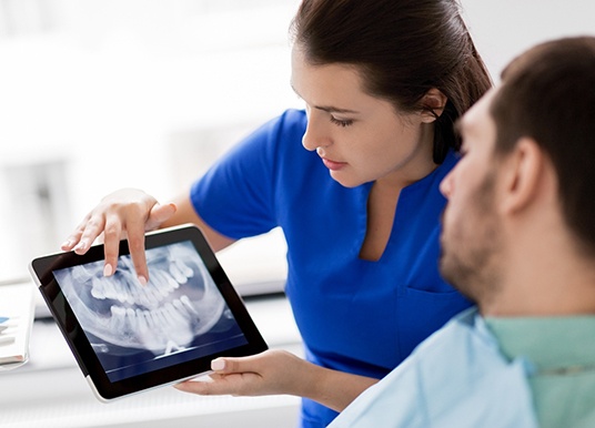 Dentist showing patient their X-rays