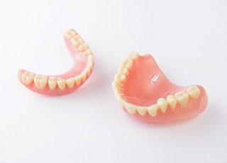 Set of full dentures in Grand Prairie on white background 