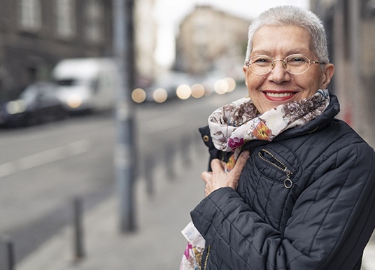 Woman smiling with dentures in Grand Prairie