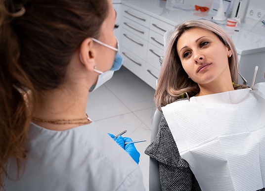 Patient in Grand Prairie talking to dentist about tooth extractions
