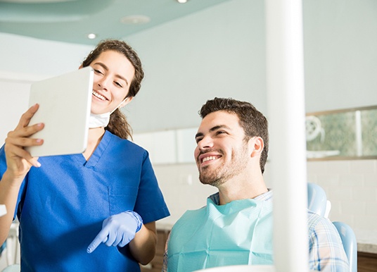 Dentist explains something to patient