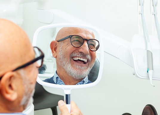 A man smiling in a mirror