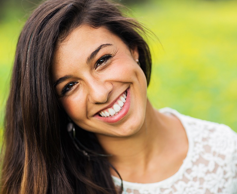 Woman smiling after periodontal therapy