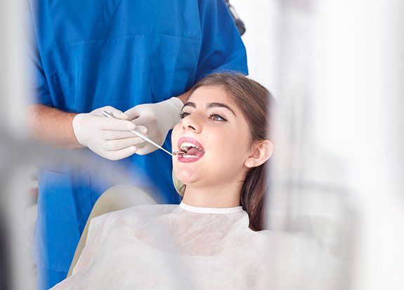 Dentist examining patient's smile