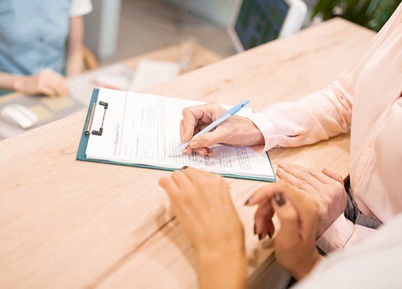 Patient completing dental insurance forms