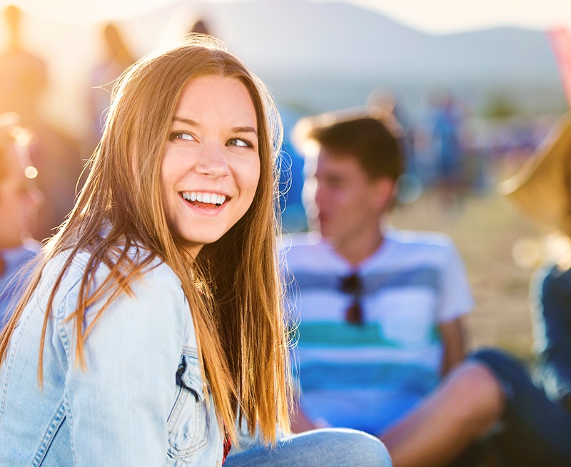 Young woman with healthy smile after Invisalign clear braces