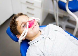 Child smiling while breathing in nitrous oxide