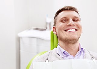 Smiling man sitting in dental office