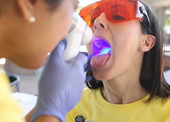 Patient receiving oral cancer screening