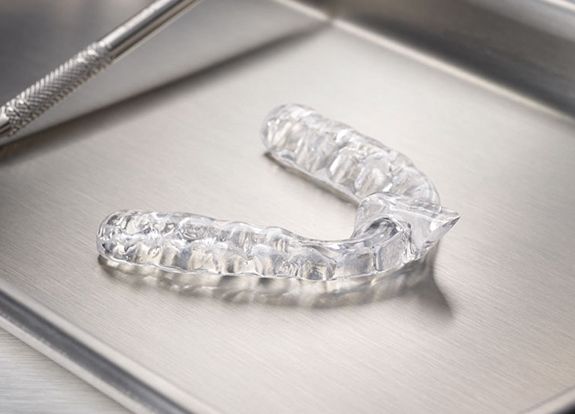 Clear nightguard for bruxism on metal tray