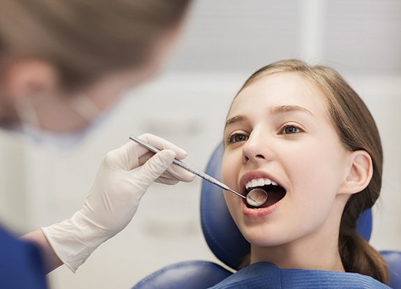 Young girl receiving children's dentistry treatment