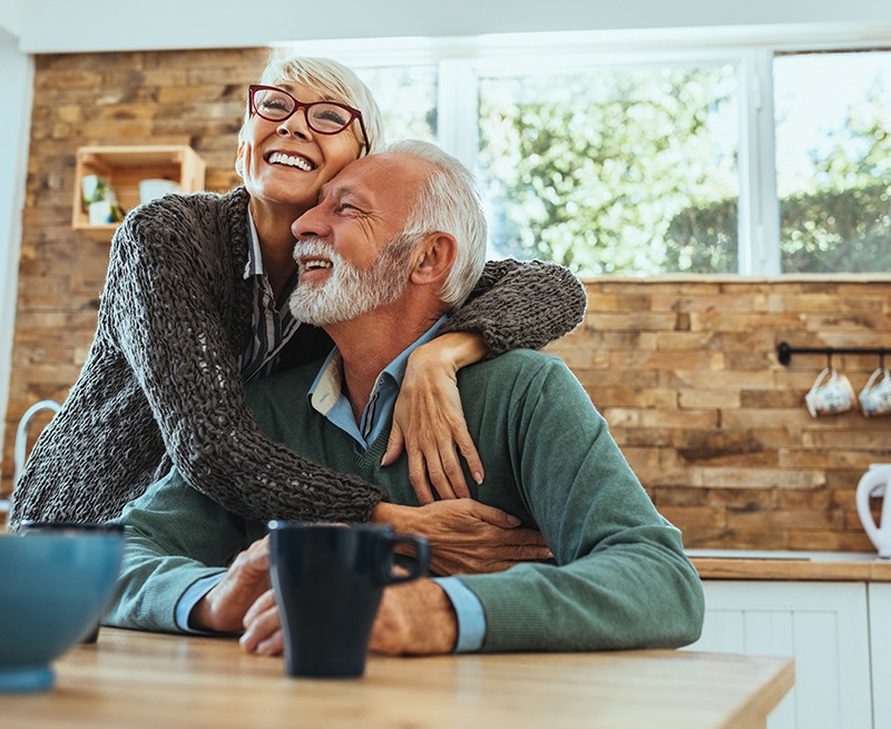 Older man and woman with healthy smiles after restorative dentistry