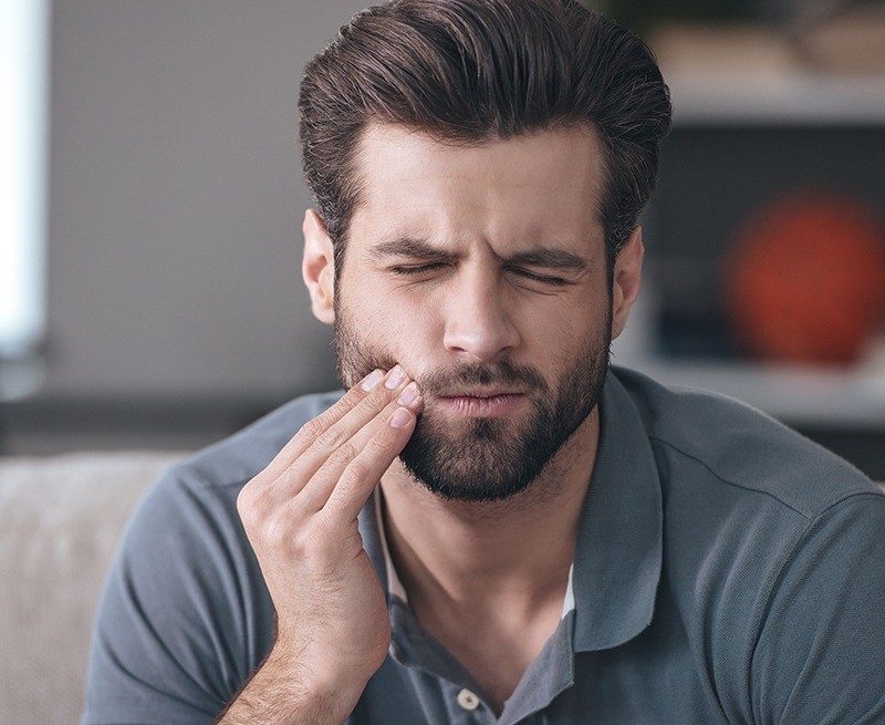 Man with toothache before root canal therapy