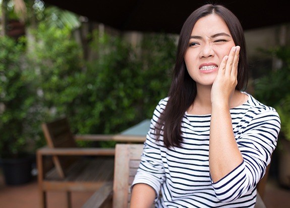 Woman in pain before root canal therapy