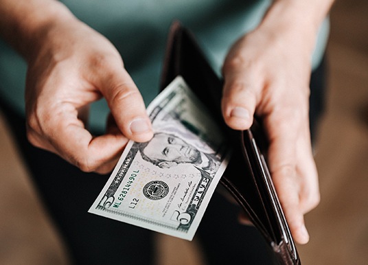 Man pulling cash out of wallet