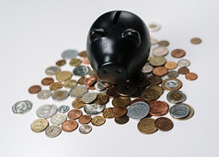 Black piggy bank on coins