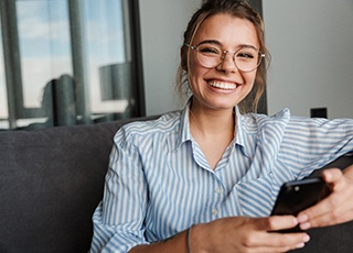 Young woman with glasses smiling in an office