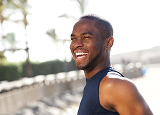 Man outside on a sunny day smiling