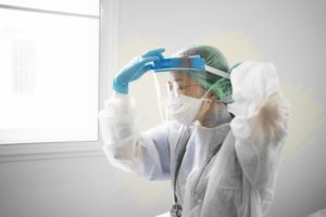 dental professional putting on increased PPE 