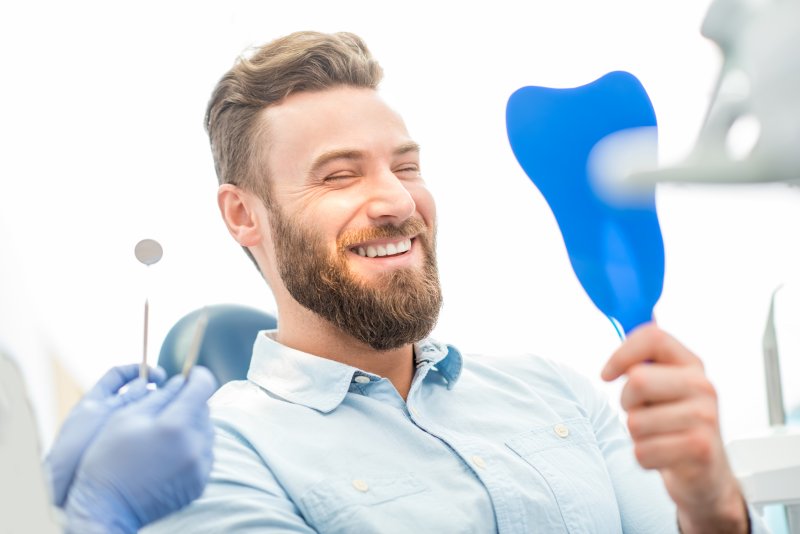 young man smiling while in dentist chair