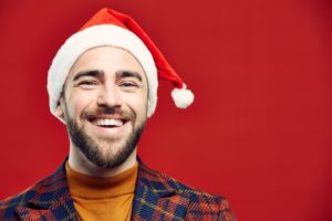smiling man wearing santa hat