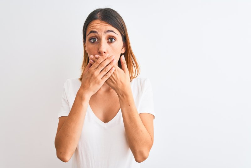 woman hiding teeth from a dentist in Grand Prairie