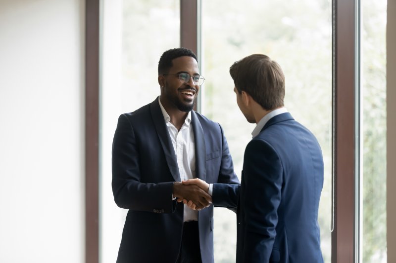 someone shaking hands and smiling