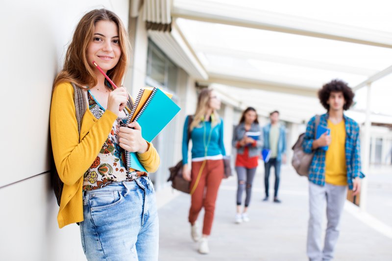 a student smiling and preparing for class