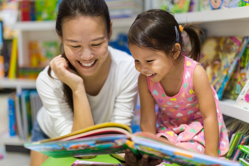 Child and mother reading about dental health