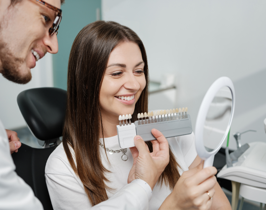 Dentist showing patient veneer options